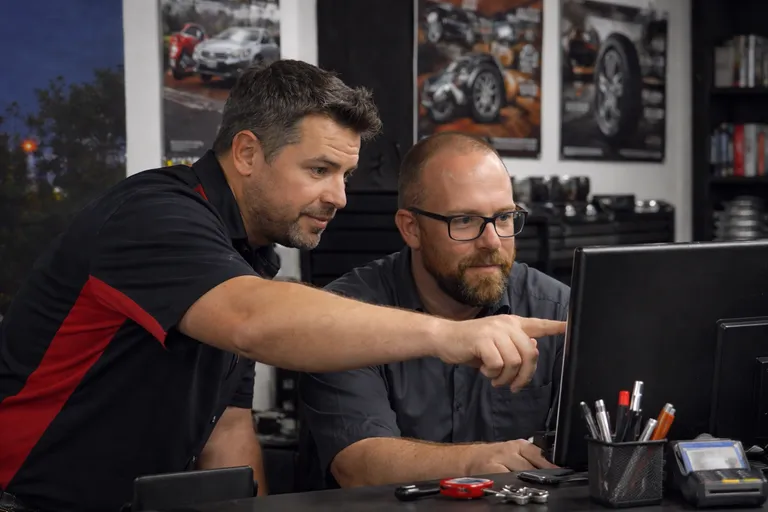 Wide shot · busy workshop working infront of the computer